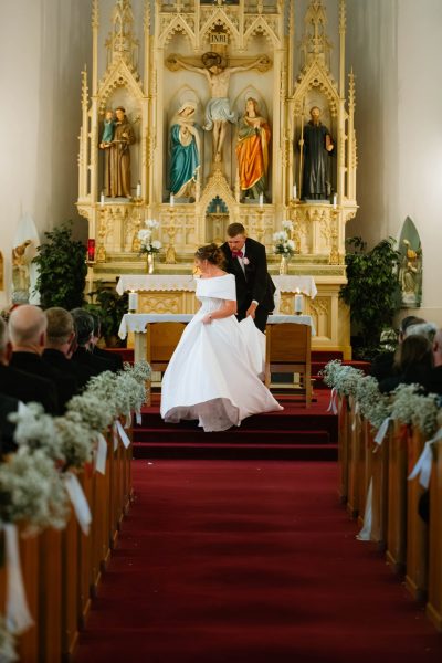 bride-groom-altar-kiss-church-wedding-irving-tx