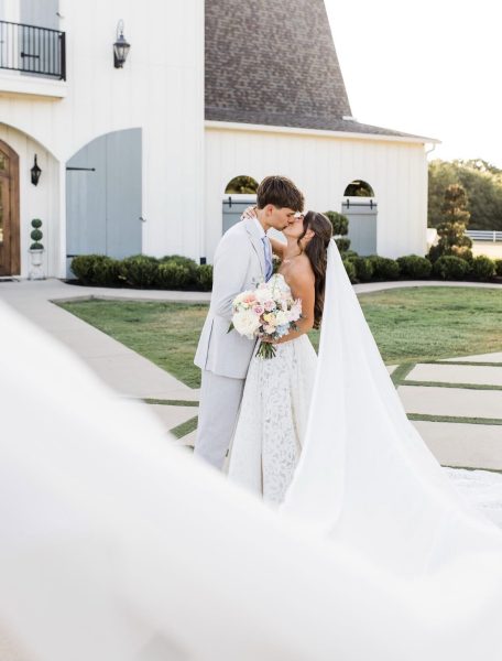 bride-groom-kiss-white-barn-venue-frisco-tx